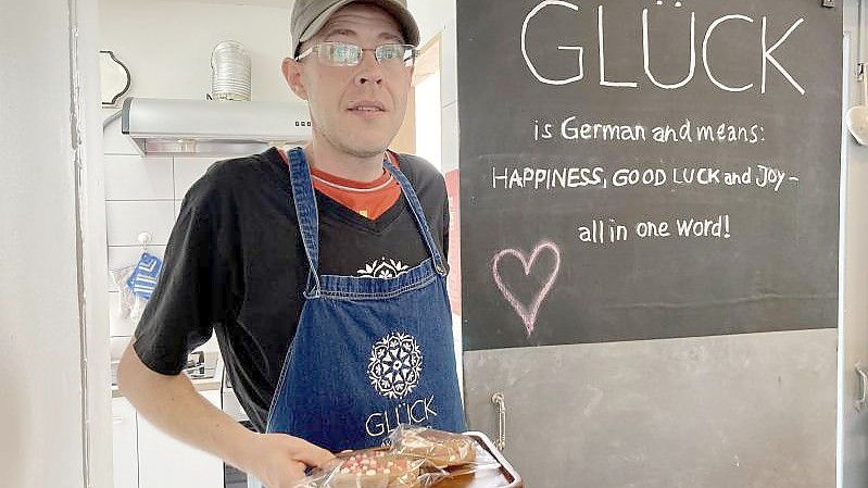 Matthias Bück vor der Küche im Café Glück in Bangkok. Hier hat der Schwabe neue Arbeit gefunden. Foto: Carola Frentzen/dpa