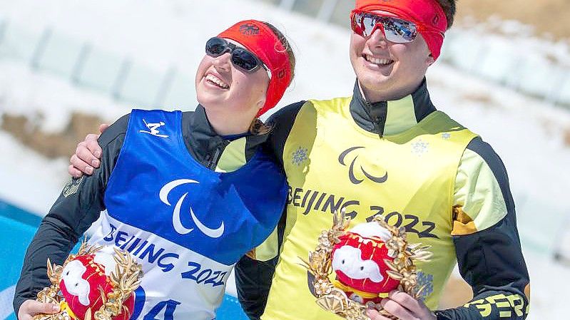 Die 18-jährige Leonie Walter und ihr Guide Pirmin Strecker feiern nach dem Rennen über 15 Kilometer ihre Bronzemedaille. Foto: Jens Büttner/dpa-Zentralbild/dpa