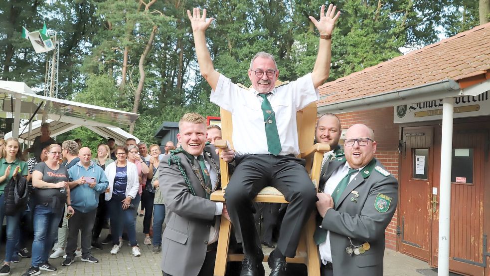 Hoch auf dem Stuhl nimmt der neue König des Schützenvereins Neuland, Siegfried Ukena, die Huldigungen des Schützenvolkes entgegen. Foto: Passmann