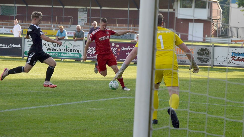 Westrhauderfehns Julian Jauken (am Ball) auf dem Weg zum Tor. Niclas Bissa (links) und Torwart Tilo Hermes vom SV Strücklingen versuchen einzugreifen. Foto: Weers