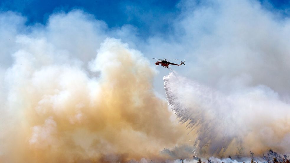 Noch immer flammen neue Brandherde auf, bekämpft wird auch aus der Luft. Foto: Marios Lolos/XinHua/dpa