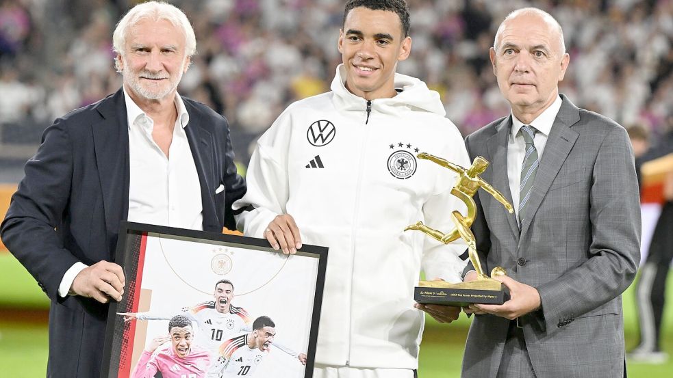 Rudi Völler (l) hört 2026 als DFB-Sportdirektor aus. Beim Ungarn-Spiel zeichnet er gemeinsam mit DFB-Präsident Bernd Neuendorf (r) Nationalspieler Jamal Musiala nach seinen drei EM-Toren aus. Foto: Federico Gambarini/dpa