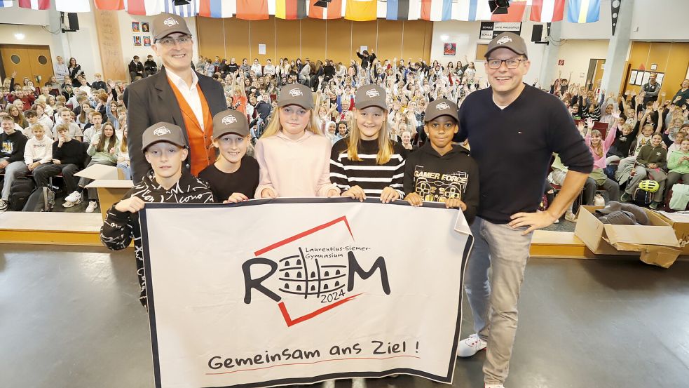 Freuen sich bei der Abschlussbesprechung in der Aula auf die Fahrt nach Rom: der Schulleiter des LSG Ramsloh, Klaus Finsterhölzl (links), sowie Koordinator Oliver Thoben (rechts) und Schüler des fünften Jahrgangs. Foto: Passmann