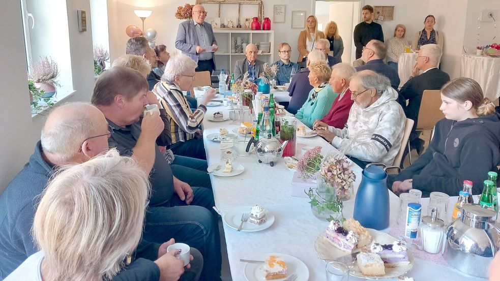 Rhauderfehn stellvertretender Bürgermeister Kai-Uwe Zeusel (hinten am Tisch) gratuliert in seiner Rede zur Eröffnung der Tagesstätte „Hofleben“.