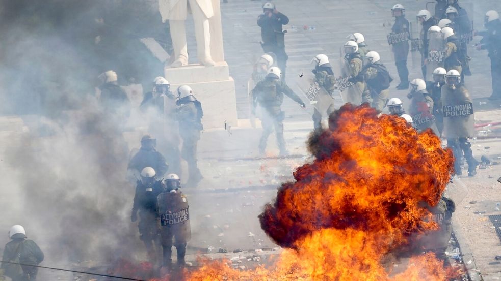 Vermummte schleuderten nach der Demo in Athen Brandsätze. Foto: Thanassis Stavrakis/AP/dpa