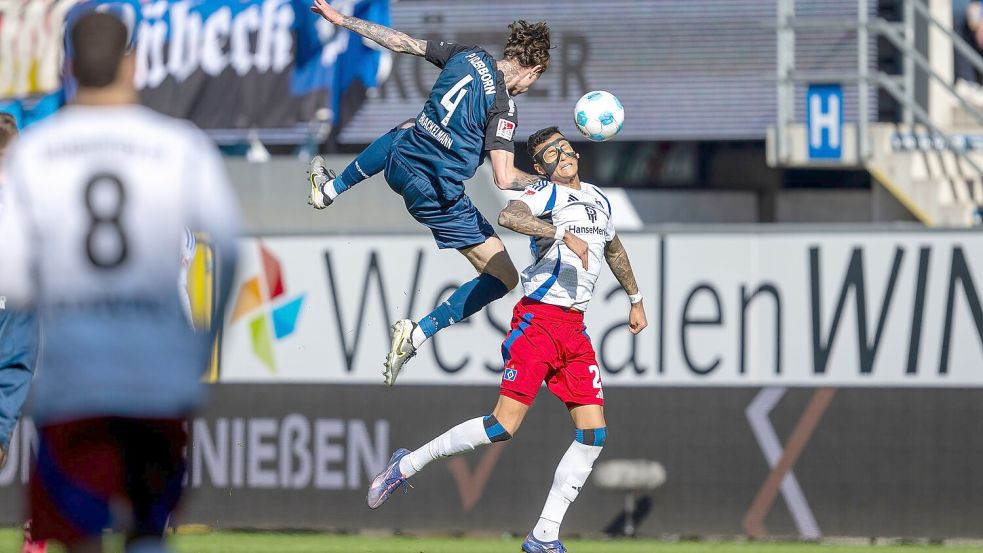 Paderborns Calvin Brackelmann (l) und Hamburgs Davie Selke kämpfen um den Ball. Foto: David Inderlied/dpa